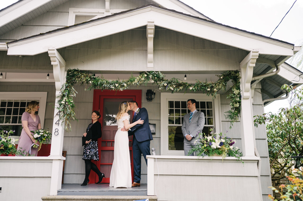  Bride and groom share first kiss on front porch of portland home 