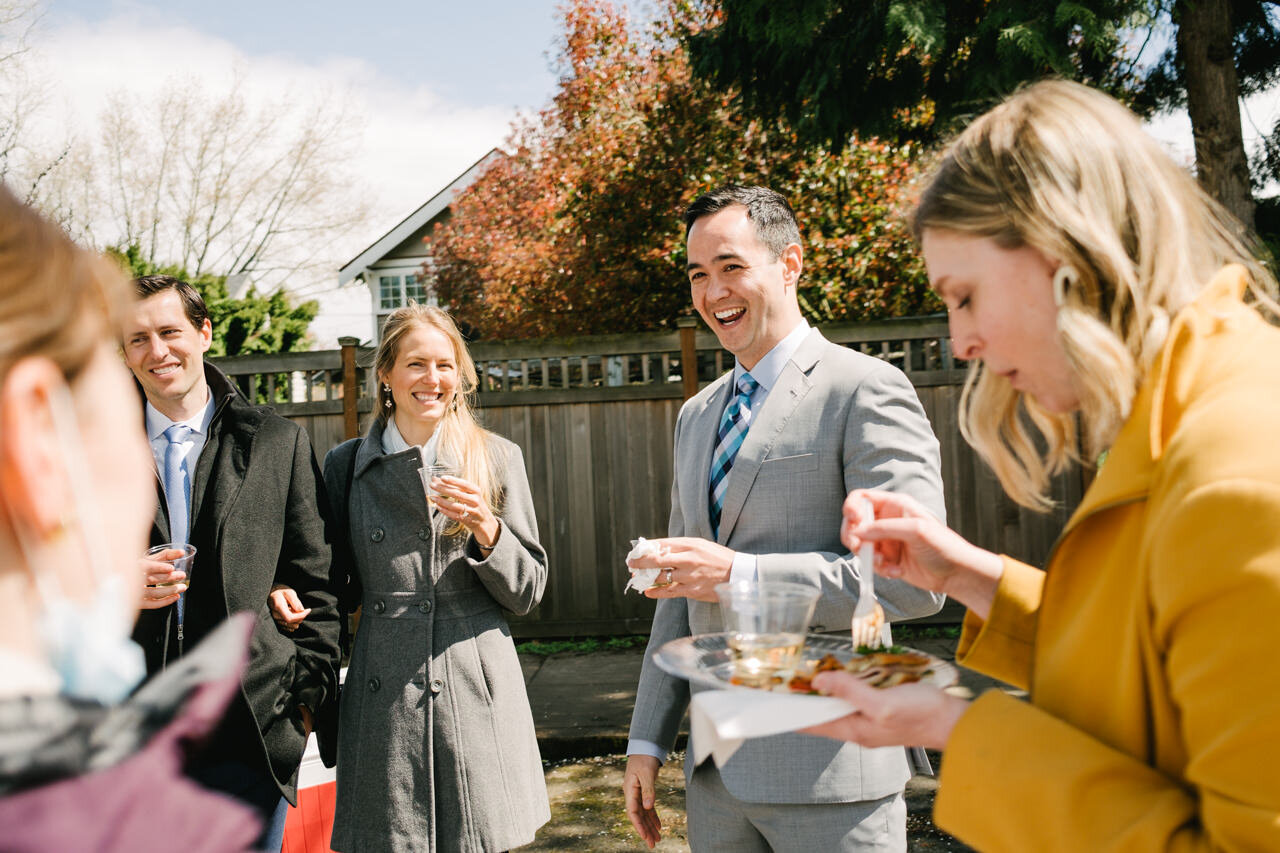  Candid moment of wedding guests laughing during appetizers 