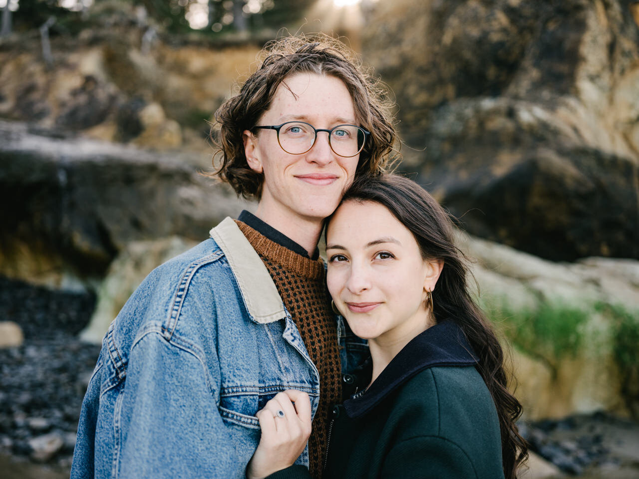  Close up portrait of engaged couple in front of Oregon coast greens and browns 