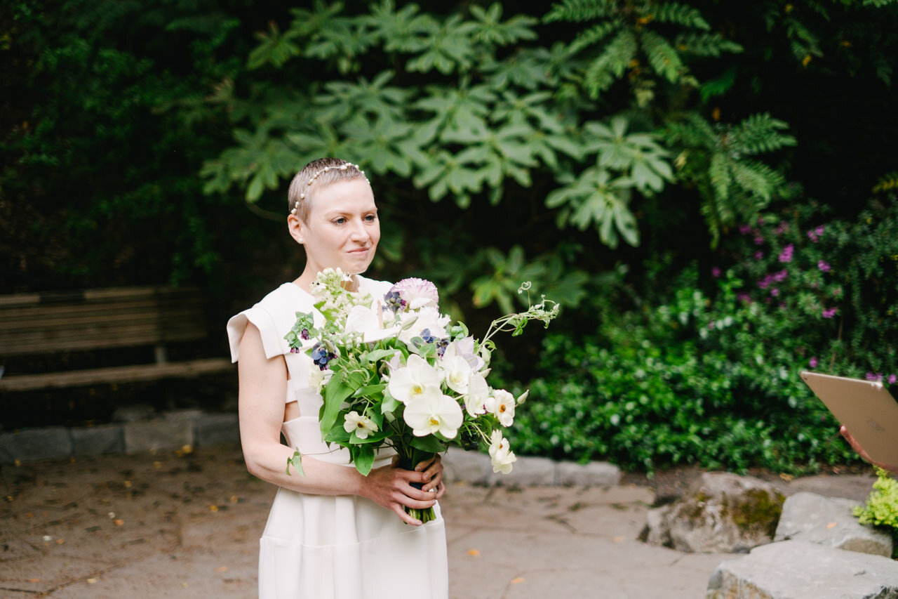  Bride with short hair and hairpiece holds bouquet at crystal springs elopement 