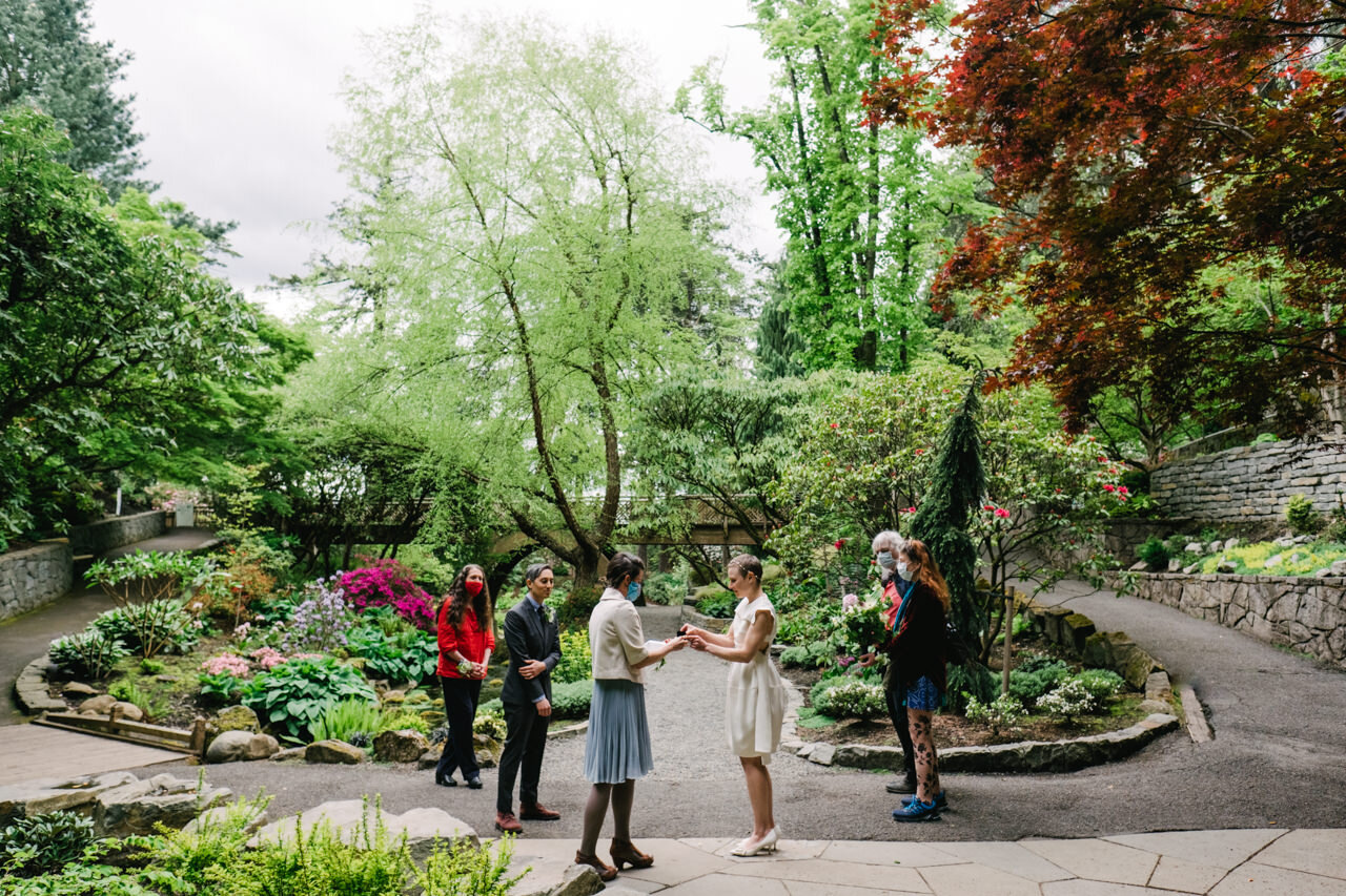  Small elopement in front of blooming flowers and walking paths at crystal springs in portland 