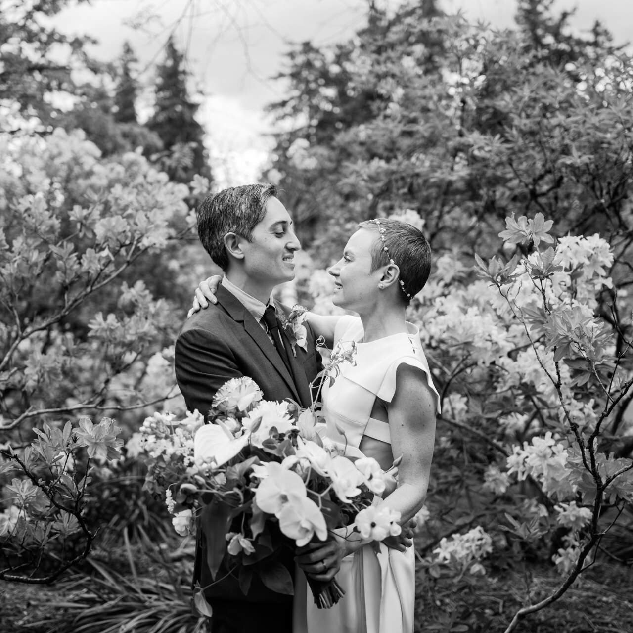  Classic wedding portrait in front of rhododendron flowers in black and white 