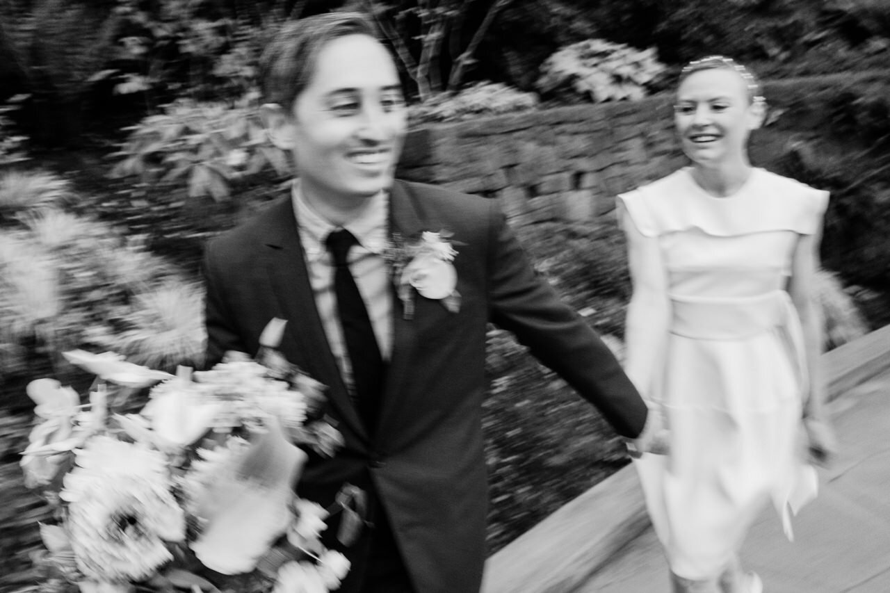  Blurry authentic black and white photo of wedding couple running 