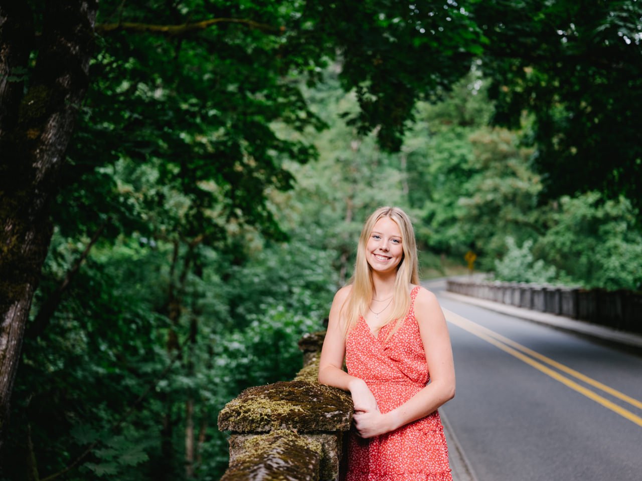  Senior portrait of girl by old highway in orange sundress 