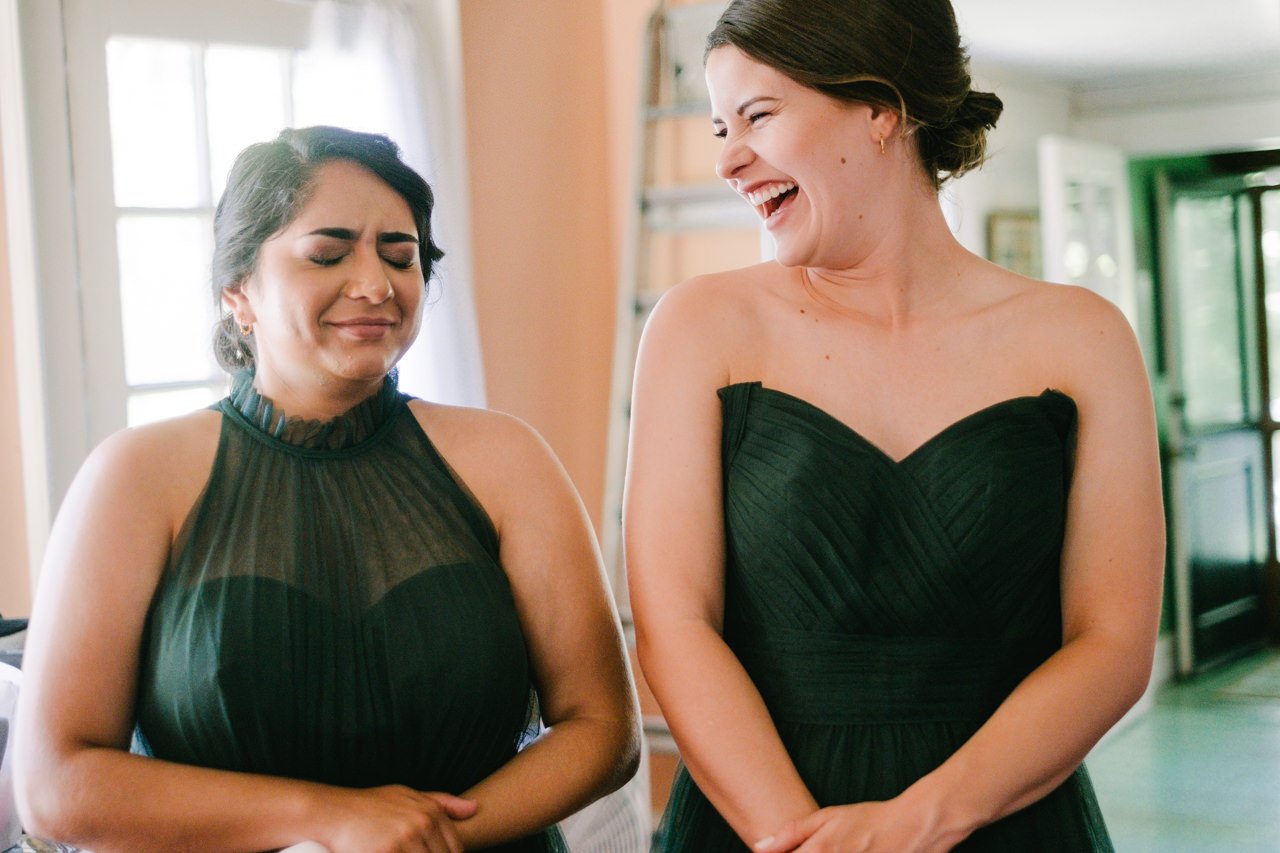  Bridesmaids in green share laugh in awkward joke moment 
