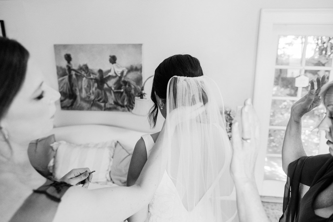  Bridesmaid fixes veil during getting ready moment 