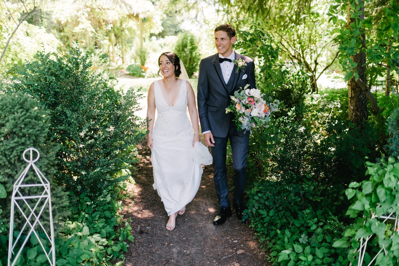  Bride and groom enter pathway to see wedding party 