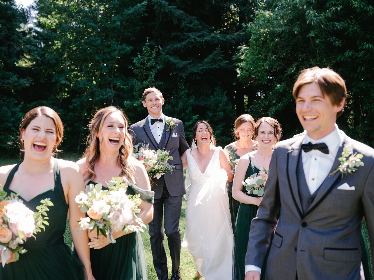  Candid moment of wedding party laughing hard and walking together 