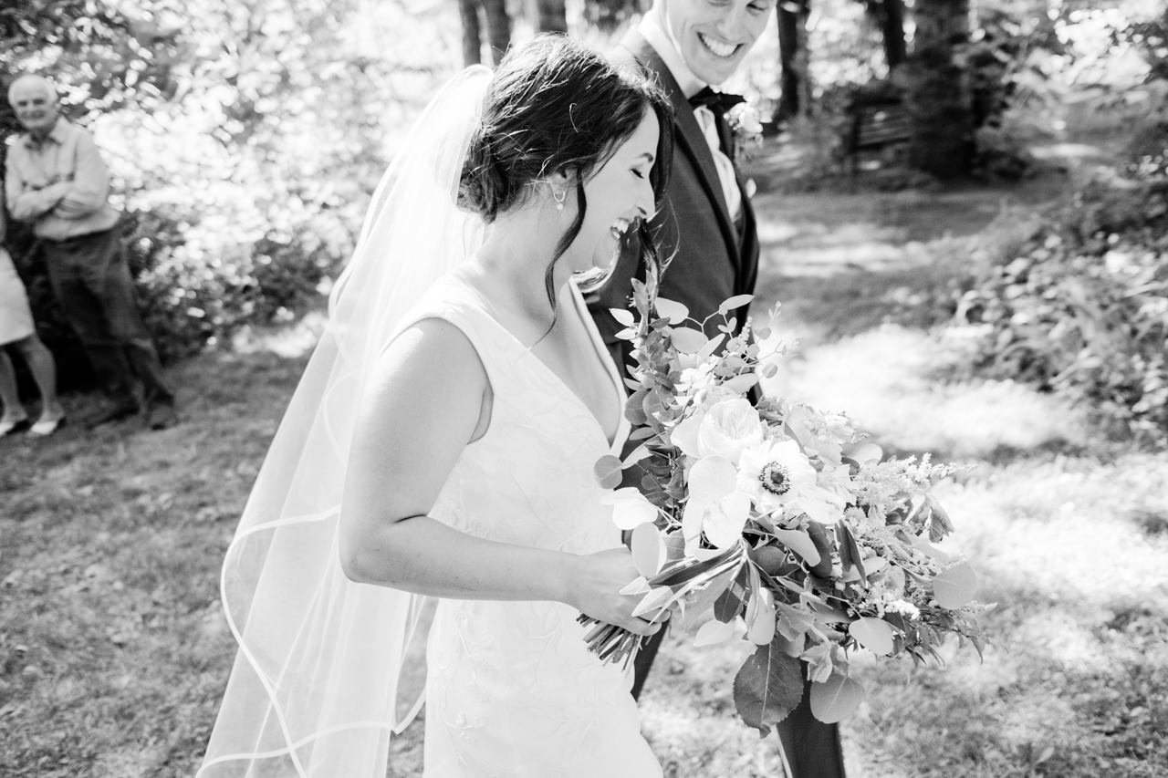  Candid smiles as couple passes by after walking aisle 