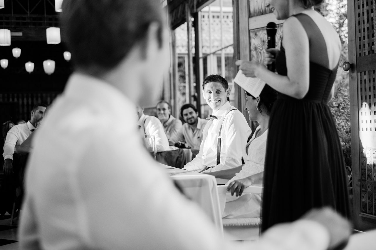  Groom shares glance with bride in black and white photo during toast 