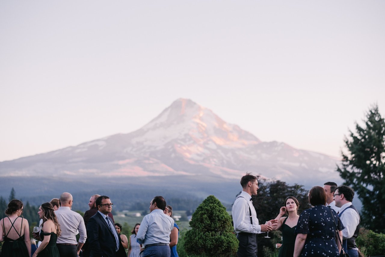  Wedding guests chat in front of mt hood evening color 