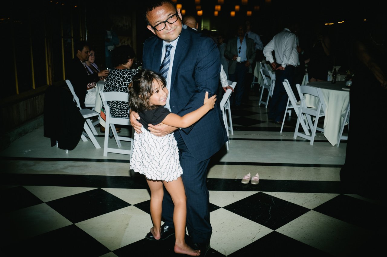  Girl dances on father's toes during dancing 