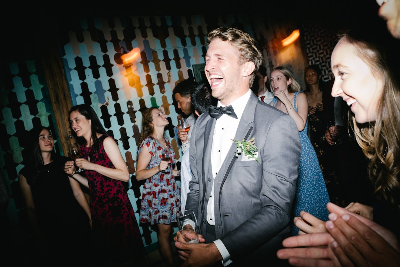  Best man laughing hysterically during reception party 