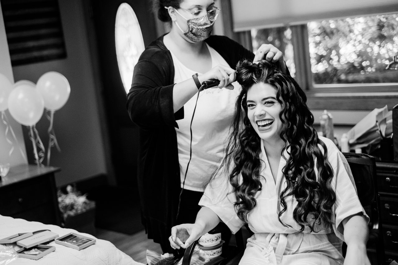  Bride laughs with hair curlers 