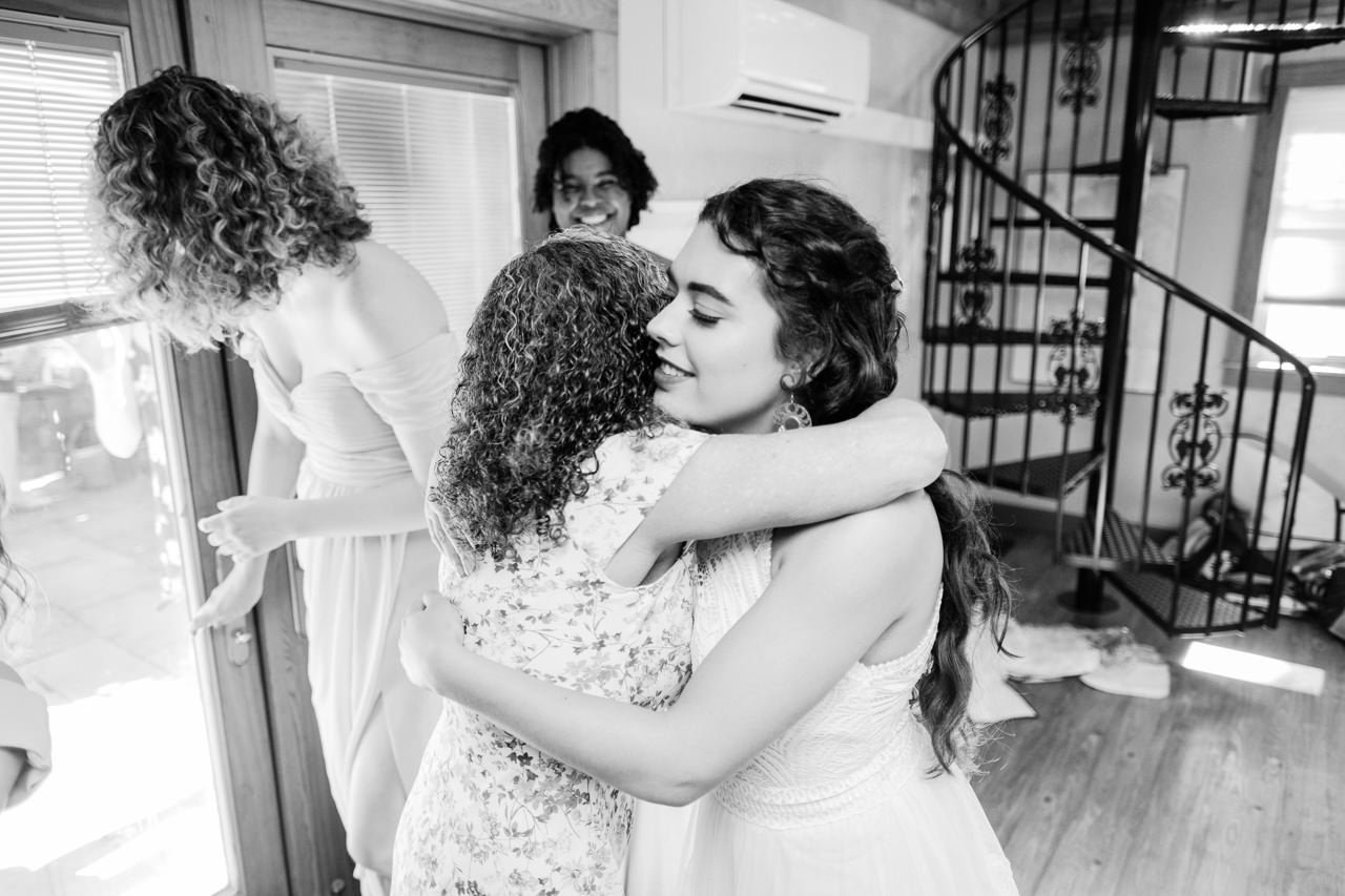  Bride hugs mother before wedding after getting ready 