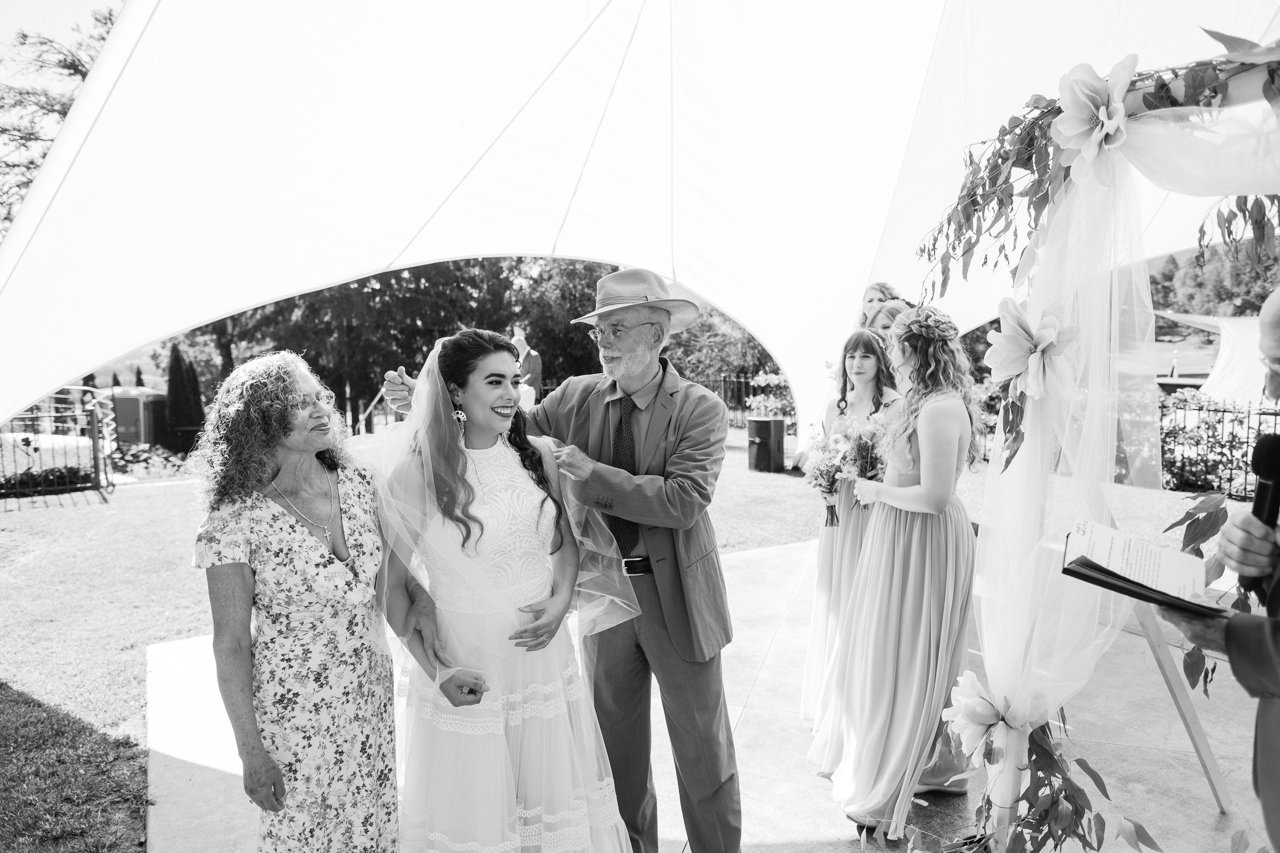  father of Bride removes veil at ceremony 