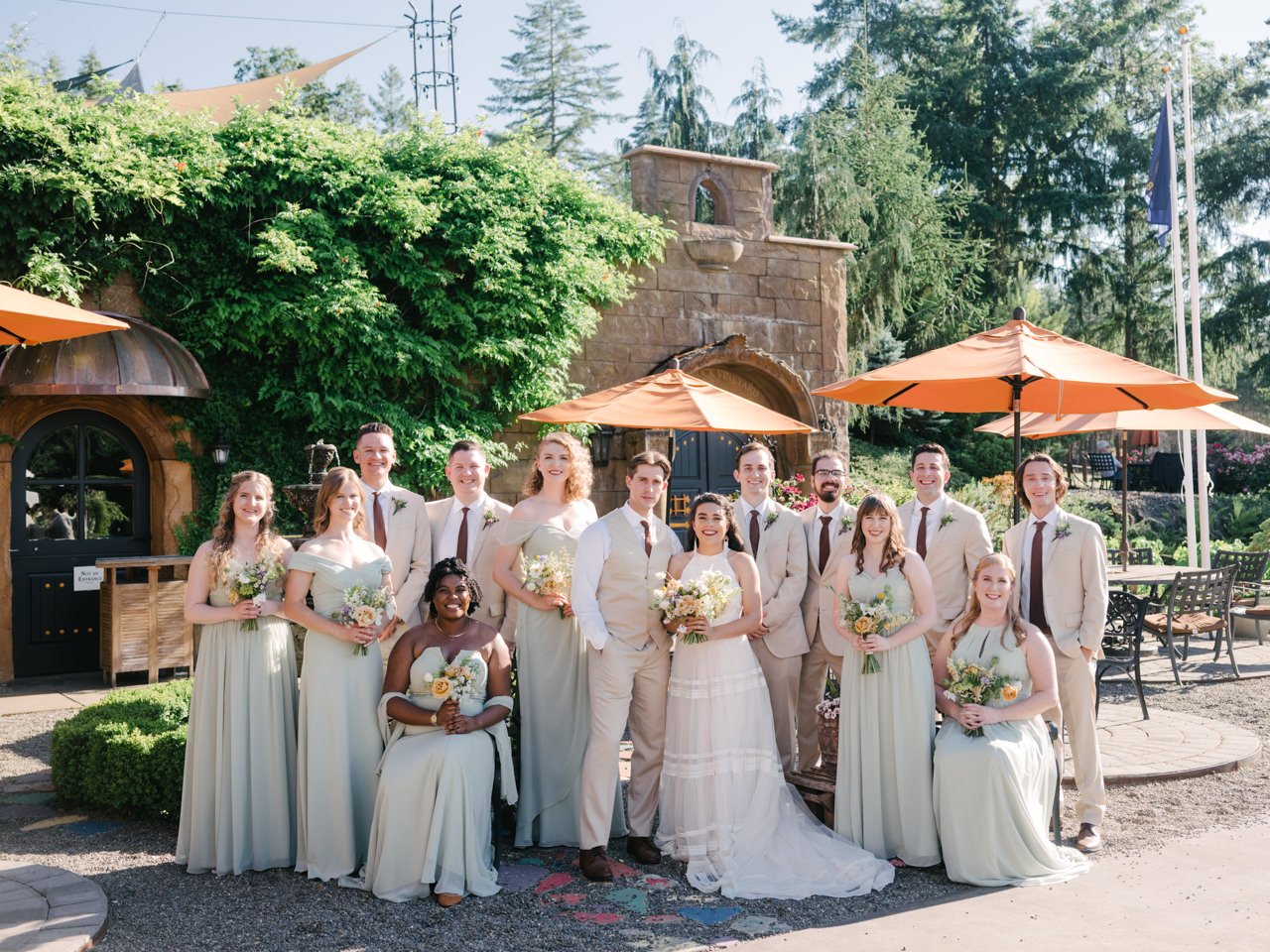  Formal wedding party portrait at reustle prayer rock vineyard with bridesmaids in green dress and groomsmen in tan suits 