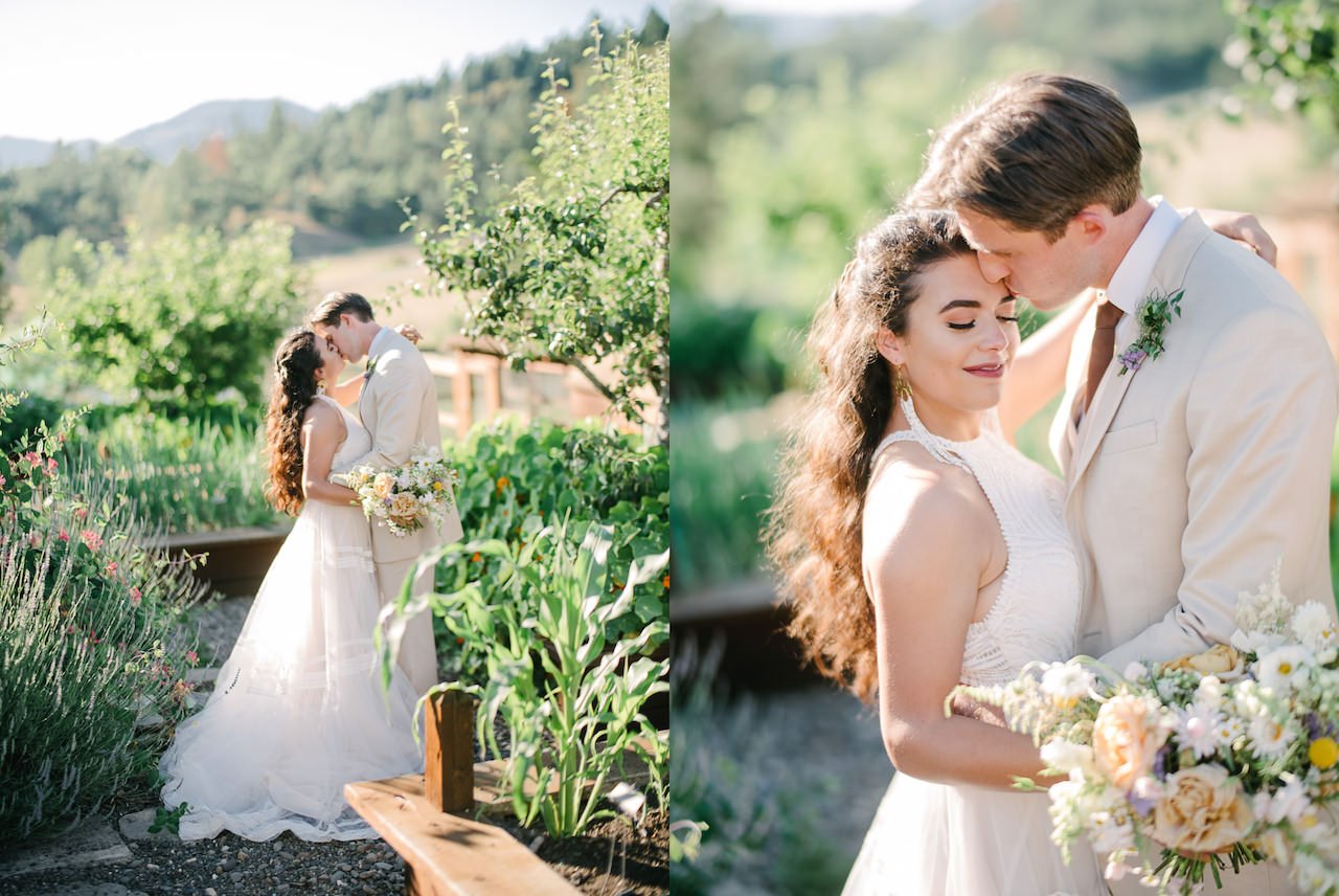  Bride and groom kiss in garden of raised beds 