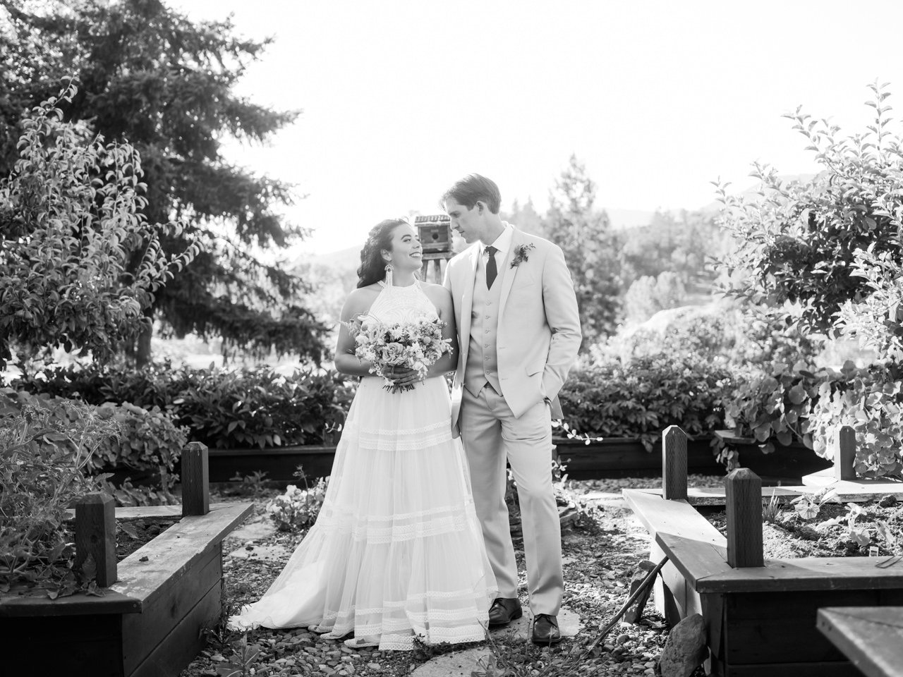  Classic portrait of bride and groom in black and white standing in raised bed garden 