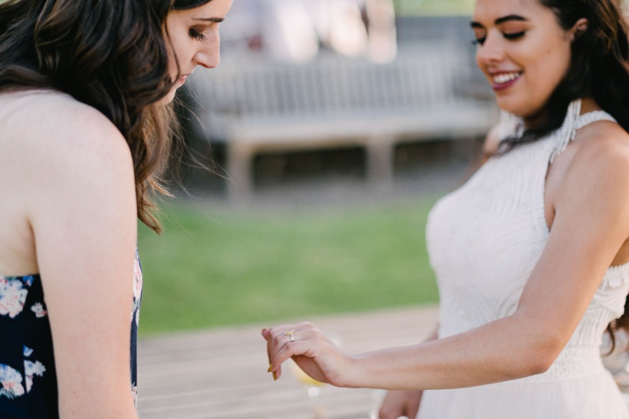 Bride shows off her ring to wedding guest 
