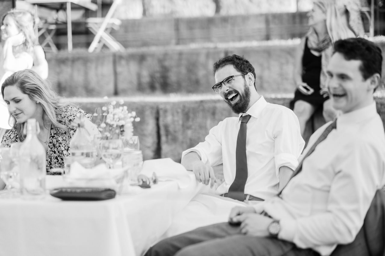  Laughing wedding guests in black and white photo 