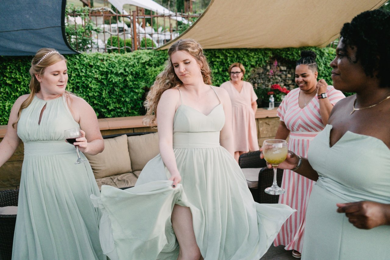  Bridesmaid in light green dress twirls skirt at reception 