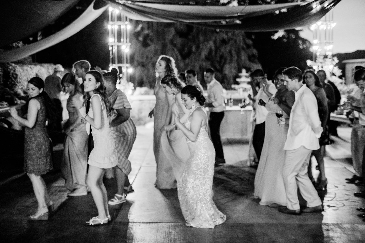  Bride and wedding guests dancing cupid shuffle in dance line 