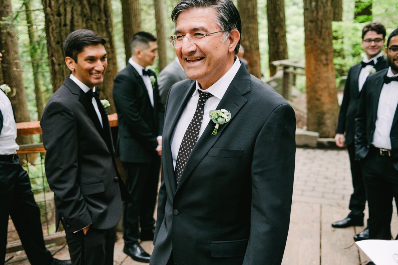  Father of bride smiling while entering wedding ceremony in Hoyt Arboretum 