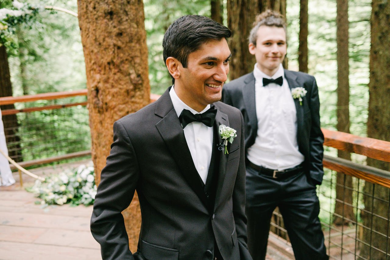  Groom smiles while waiting on redwood deck before the ceremony 