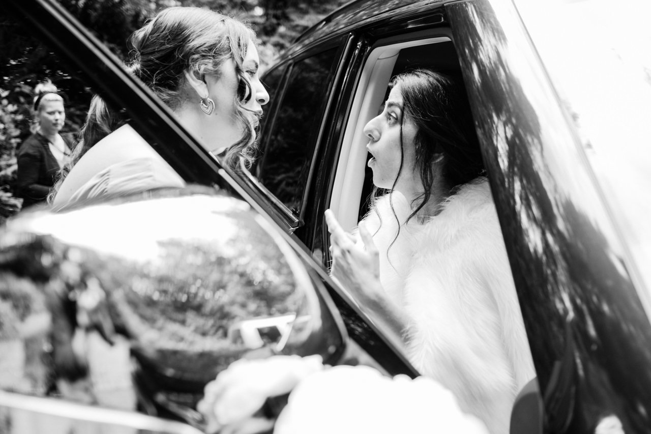  Bride reacts surprised while waiting in the car before ceremony 