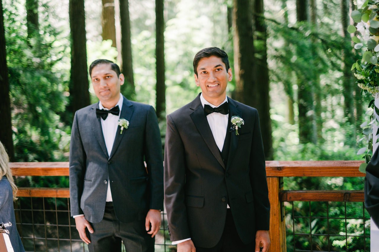  Indian Groom and his brother watch bride walk down forest park aisle 