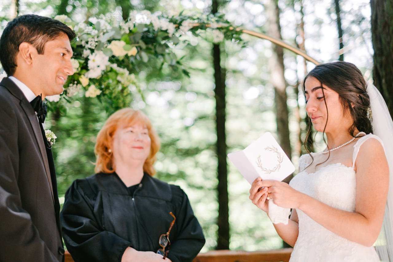  Bride tears up during emotional vows with redwood trees behind her 