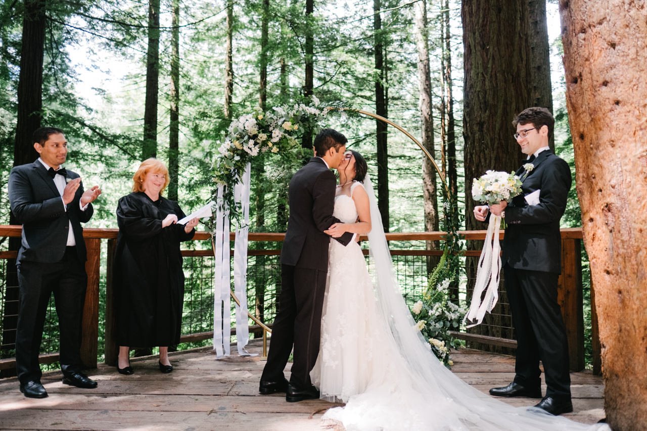  Bride and groom kiss at ceremony on redwood deck 