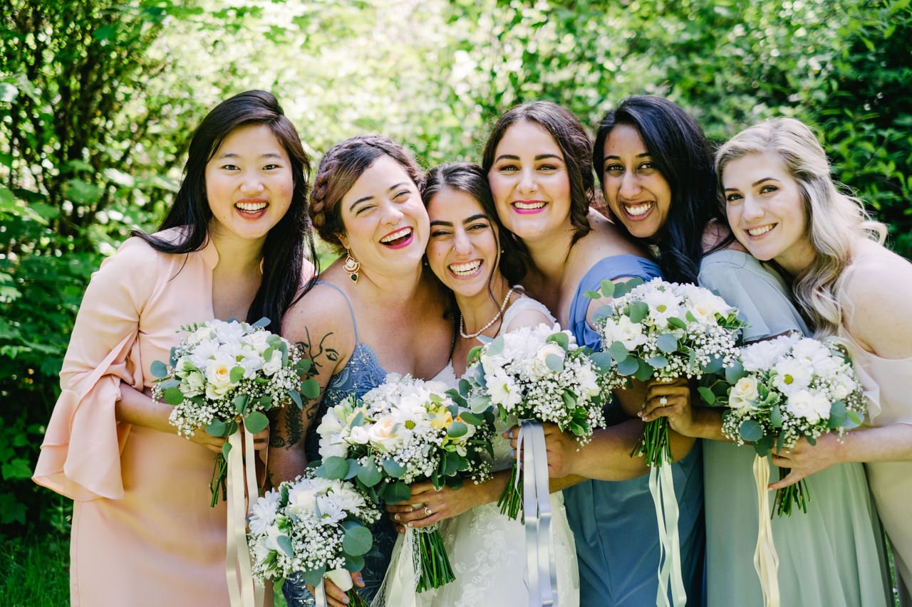  Closeup of bridesmaids laughing with baby breath bouquet 