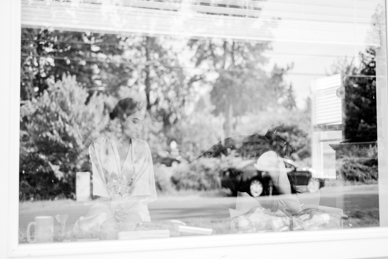  Bride stands in window reflections 