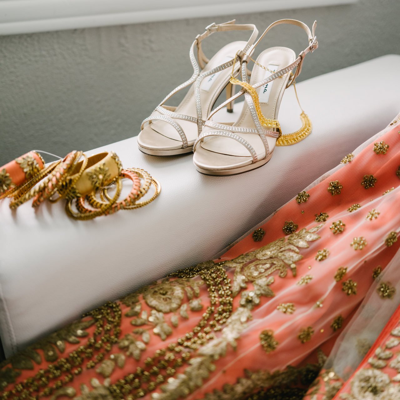  Detail photo of Indian bridal attire and pink and gold sari and bangles 