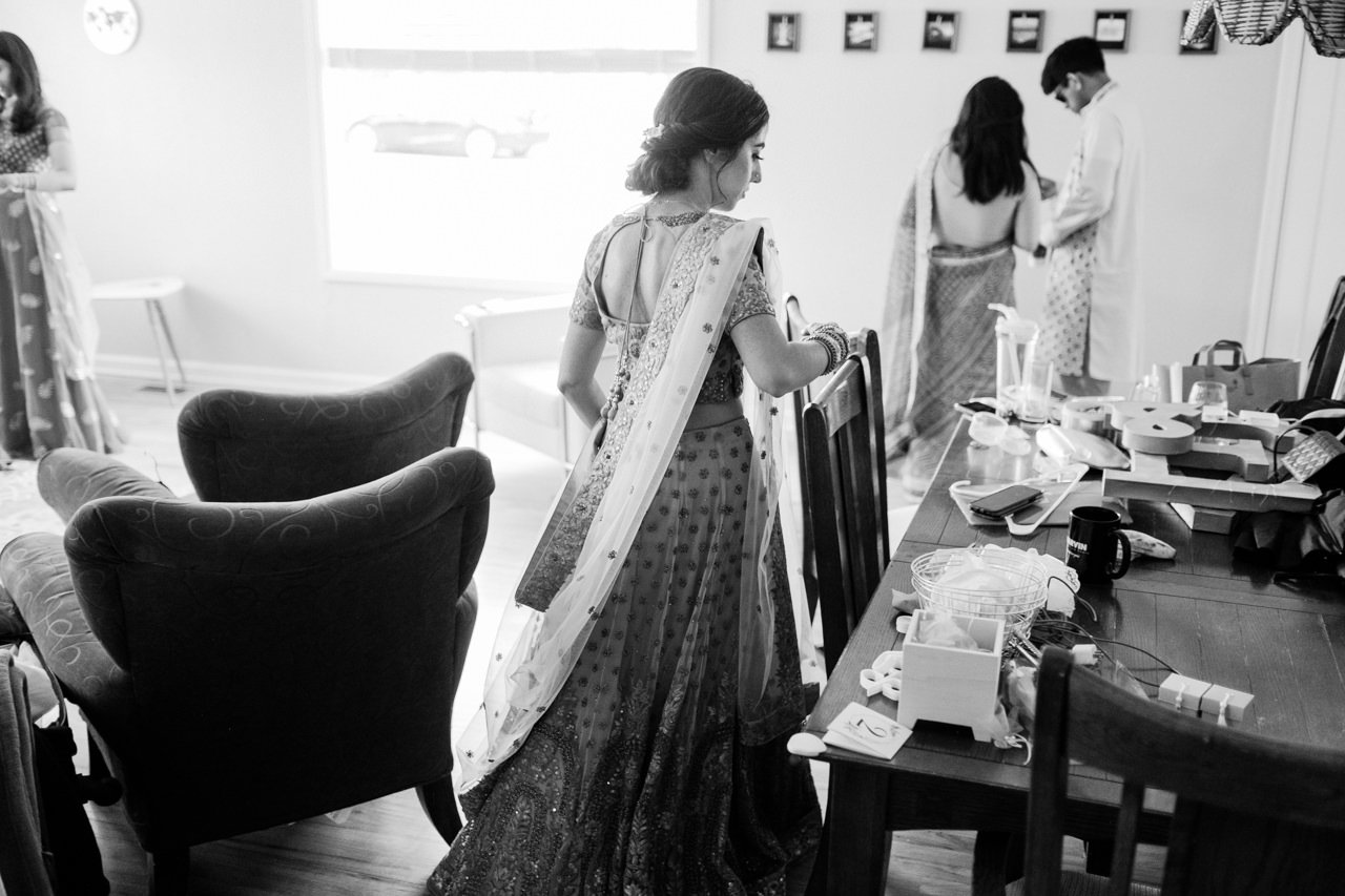  Candid photo of bride in sari leaving house 