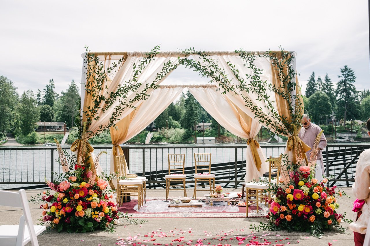  Colorful floral mandap in front of willamette river 