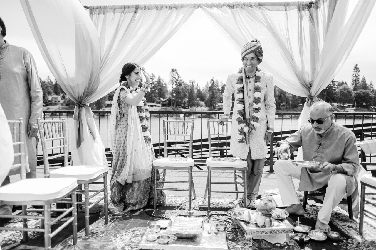  Indian bride and groom greet everyone while sitting down to ceremony 