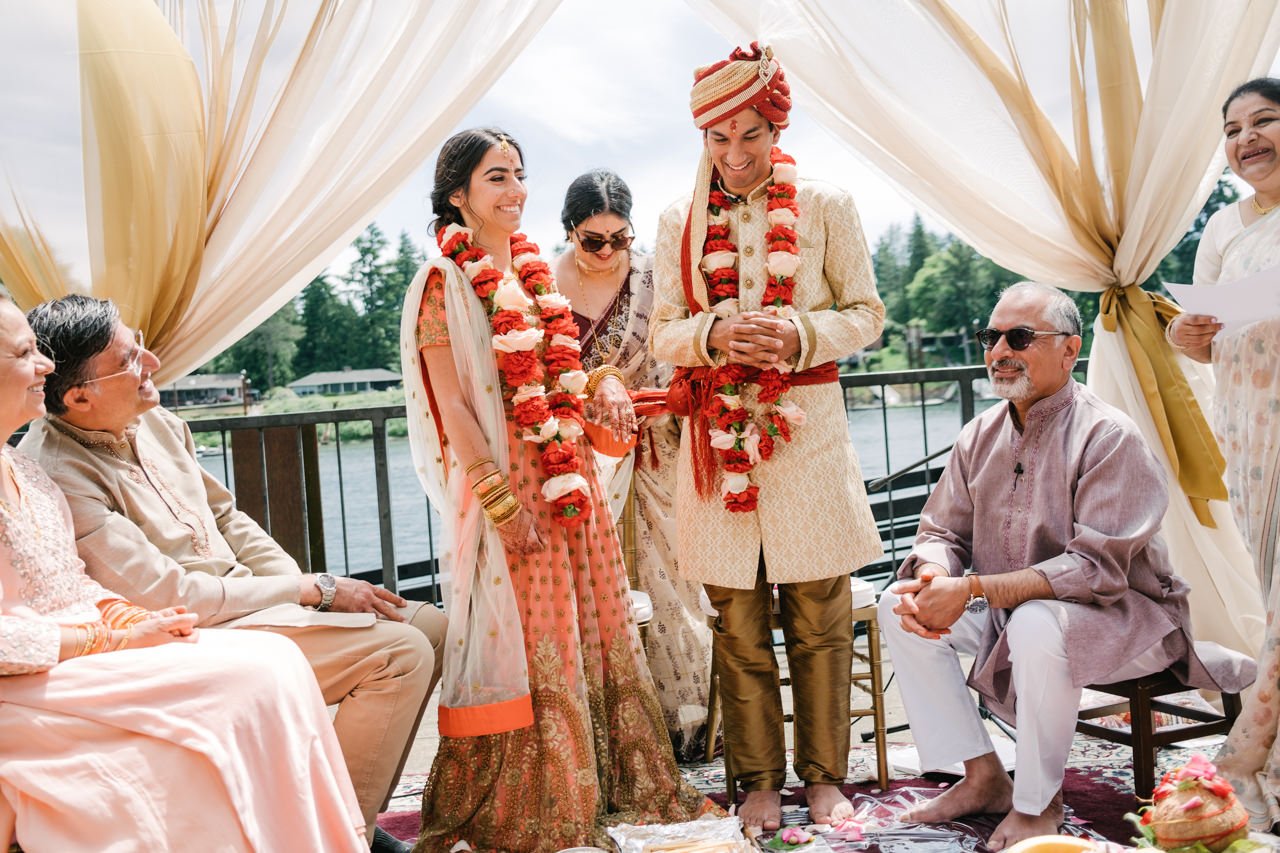  Indian wedding ceremony by river with gold pink and red 