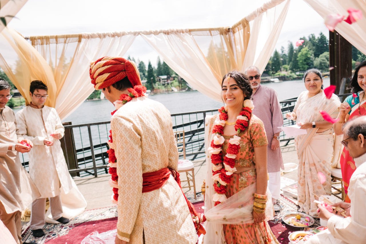  Indian bride smiles while walking around fire in mandap ceremony 