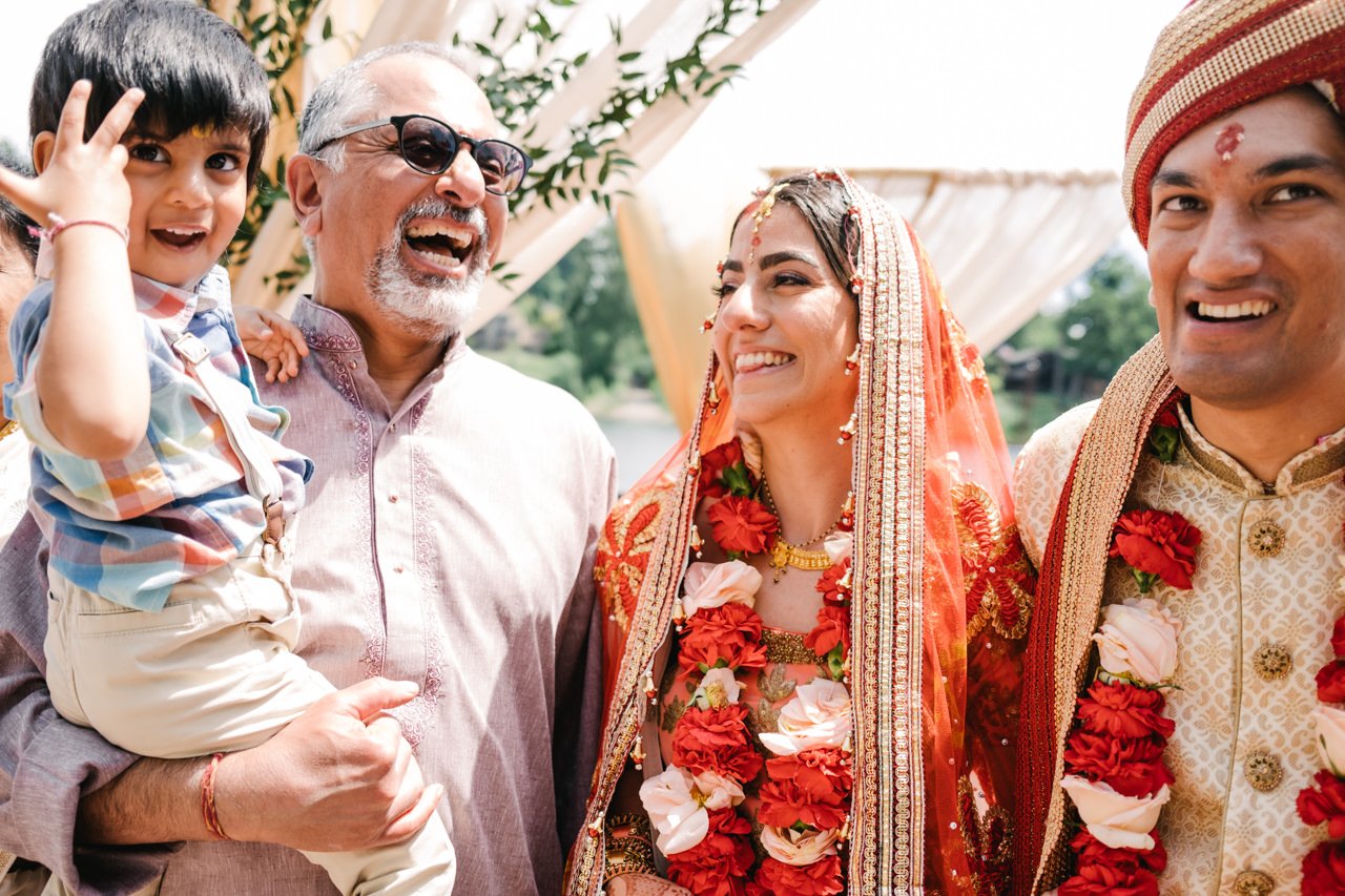  Indian wedding couple laugh with child and uncle 