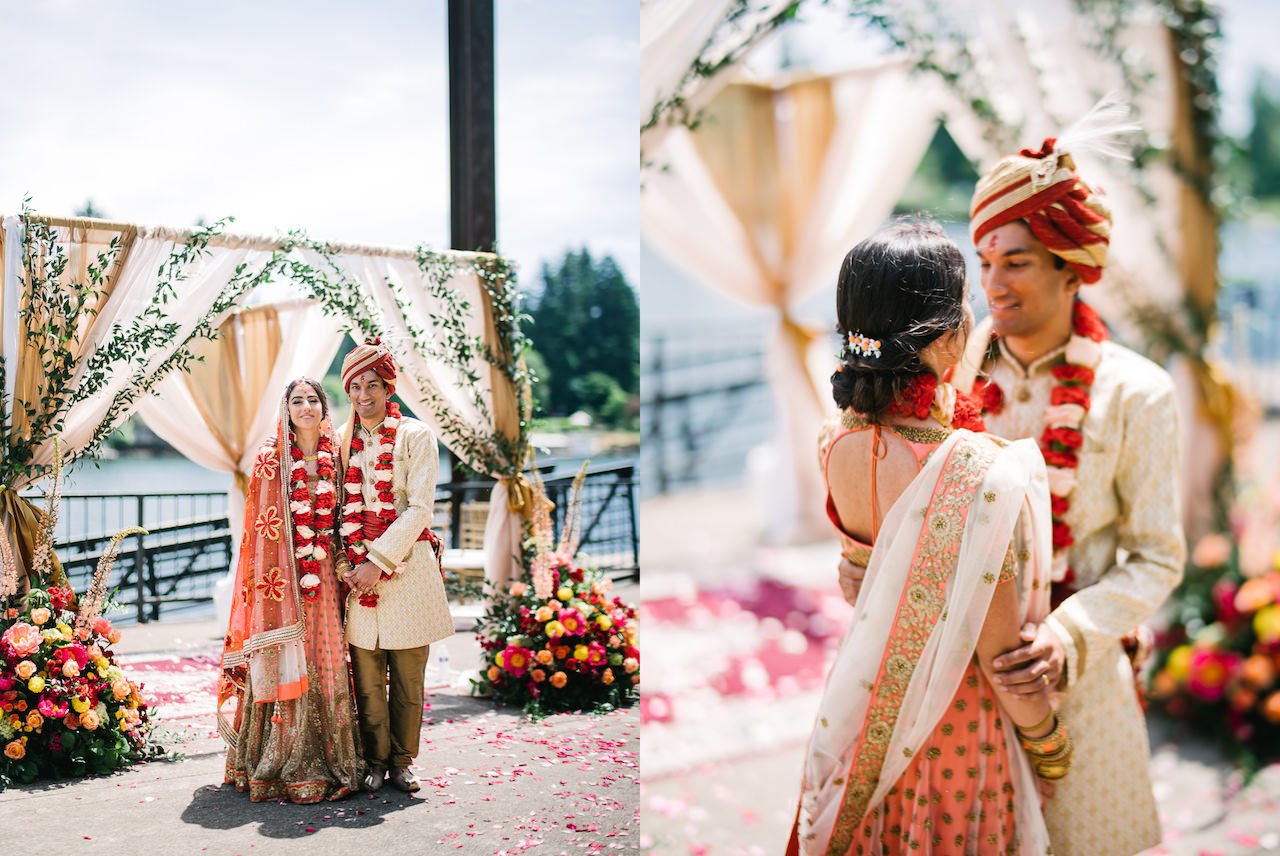  Indian bride in wedding shawl and groom portrait under beautiful floral mandap 