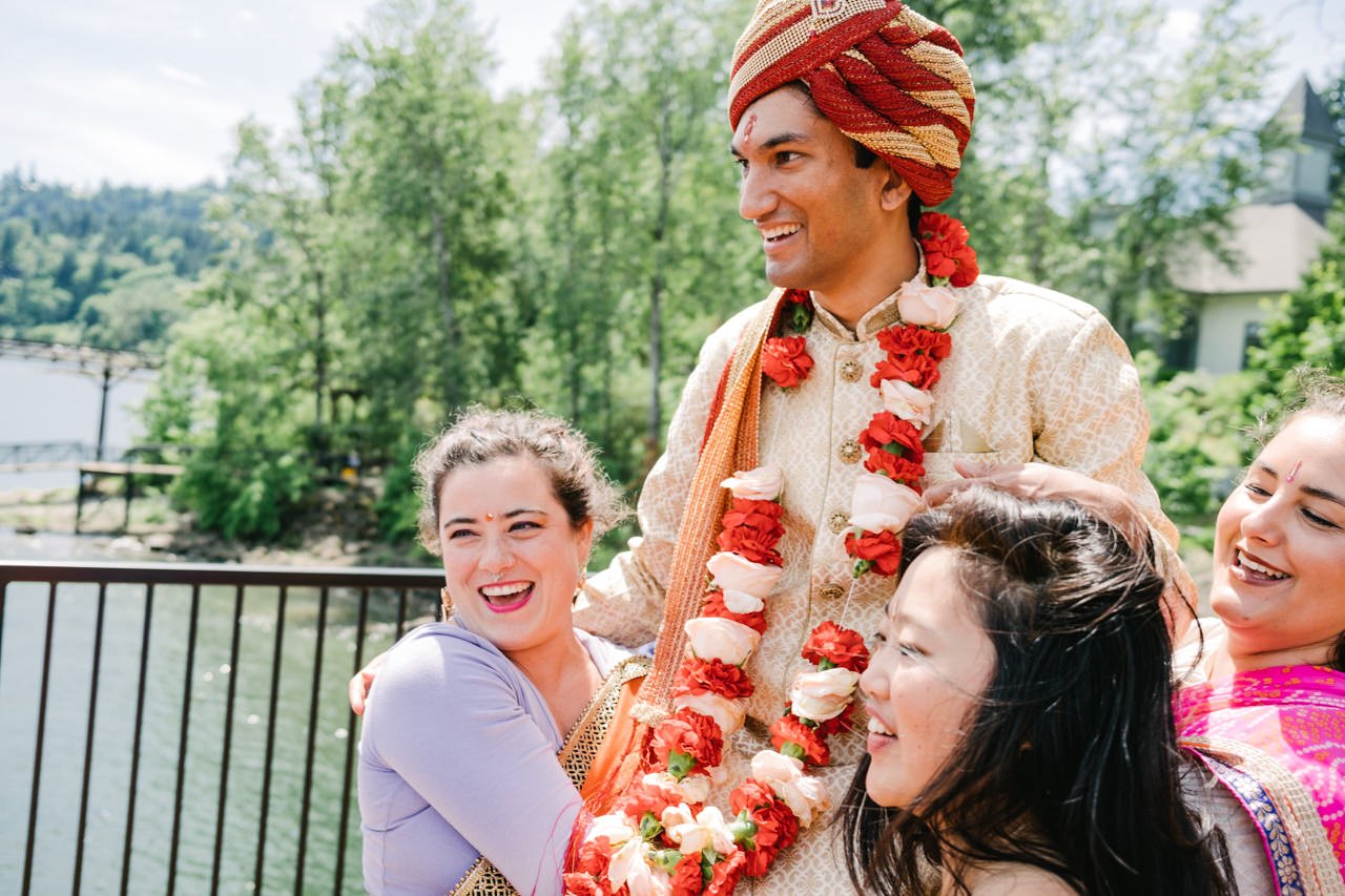  Groom lifted up by wedding party smiles with red turban 