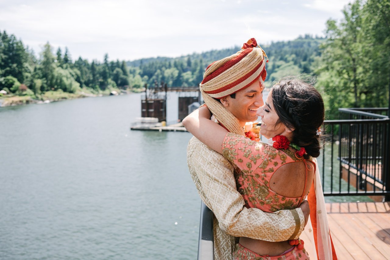  Bride and groom share moment by river at Roehr park in Lake Oswego after Indian wedding ceremony 