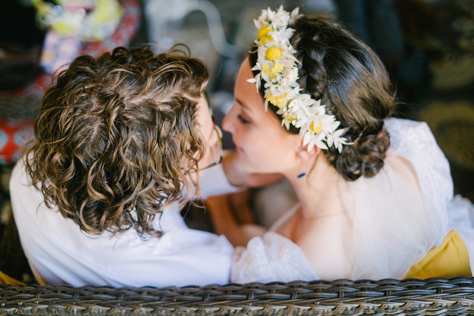  Bride with flower crown sits almost kisses 