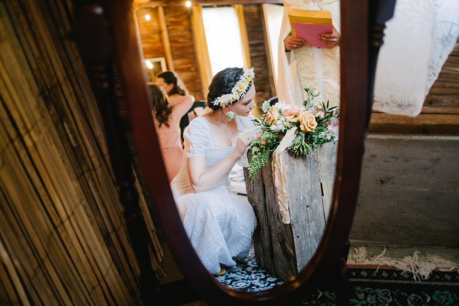  Bride signs marriage license in mirror with bouquet 