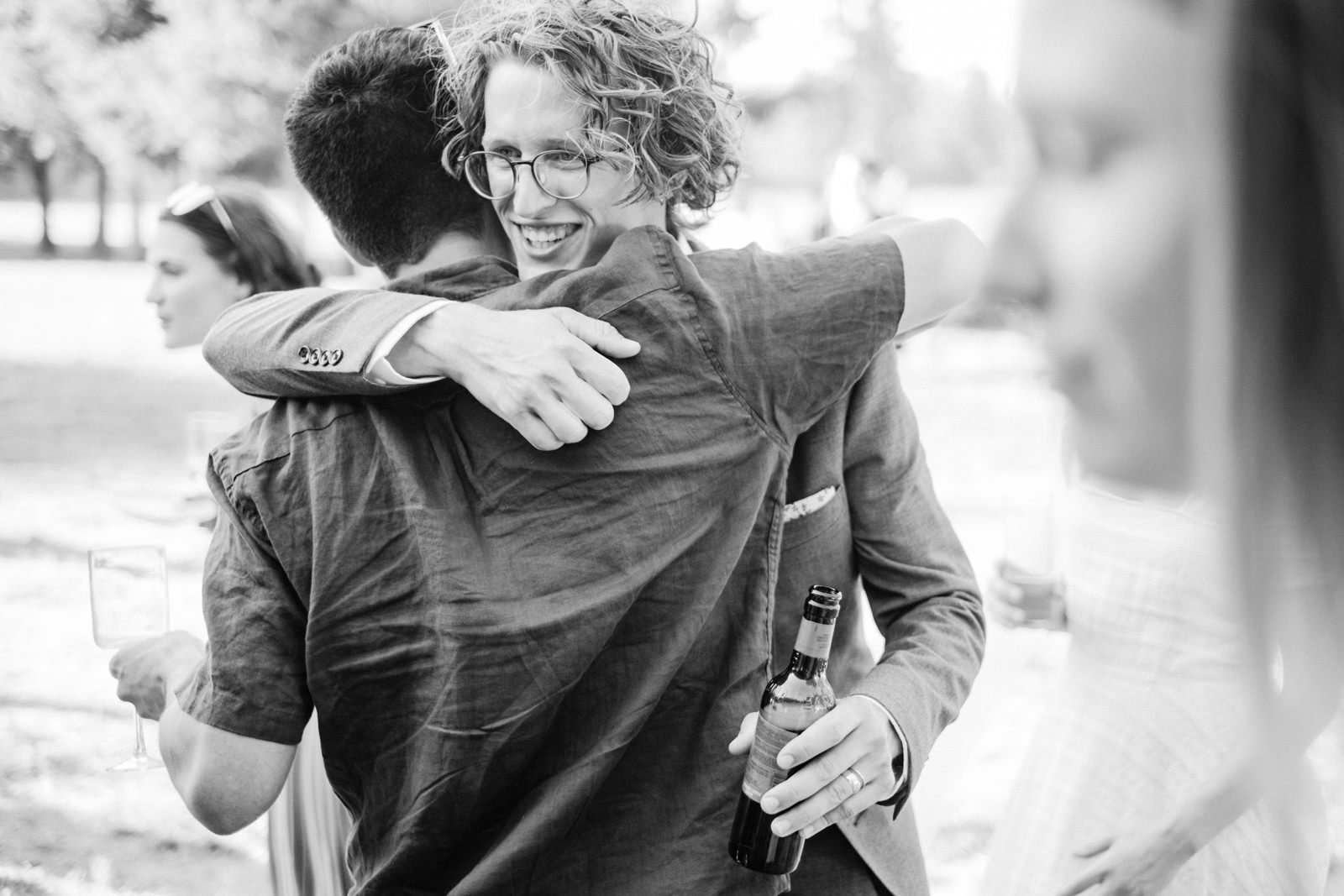  Groom hugs guest in candid moment 