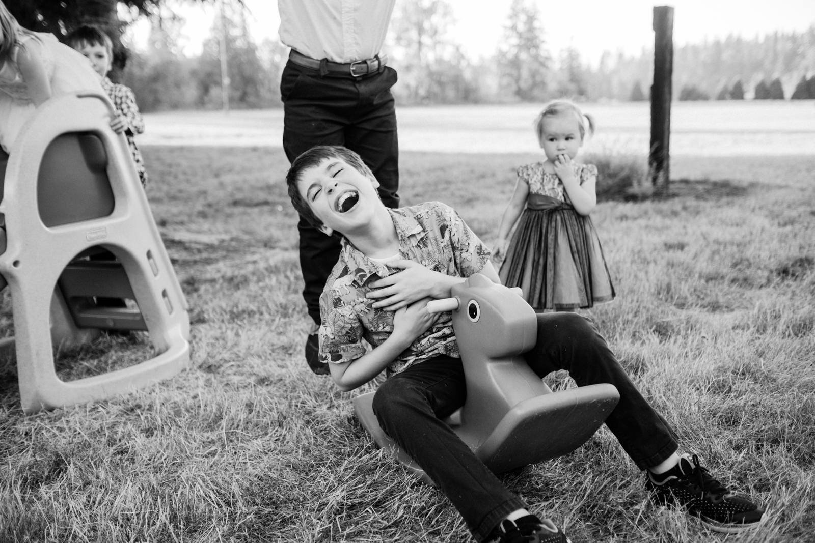  Boy laughs hysterically on toy rocker 