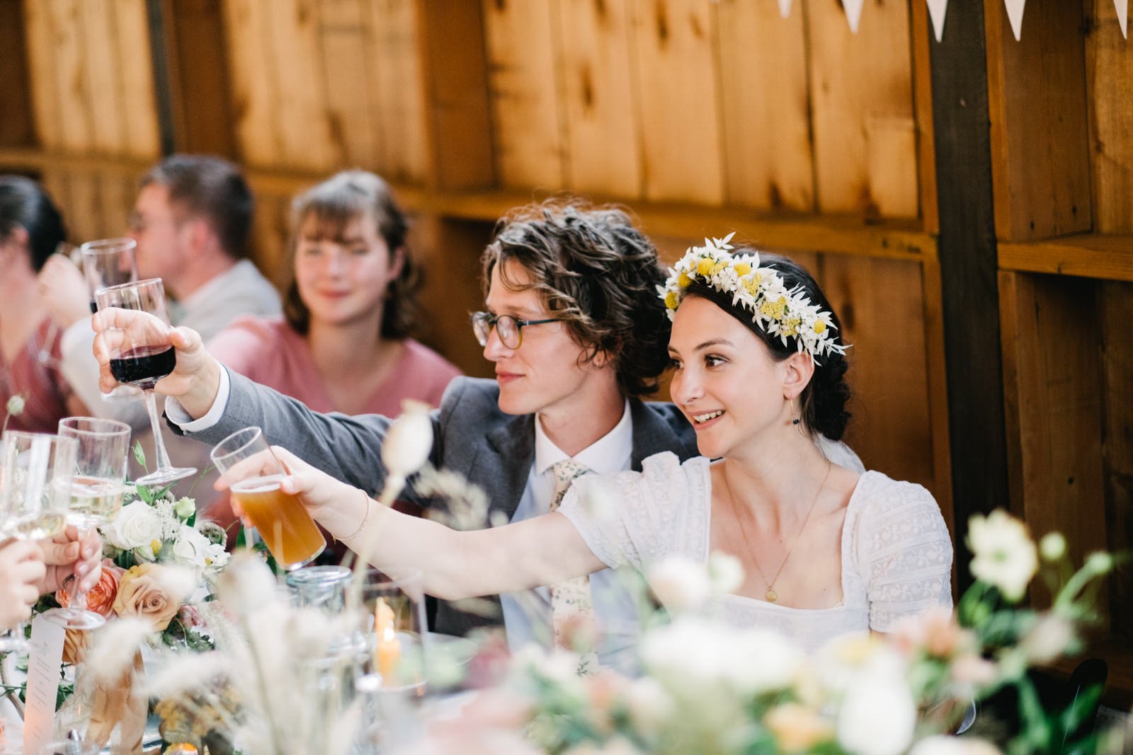  Bride and groom cheers wine and beer with table 